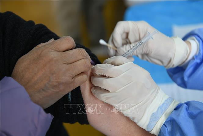 Trong ảnh: Nhân viên y tế tiêm vaccine ngừa COVID-19 cho người dân tại tỉnh Chiết Giang, Trung Quốc, ngày 7/12/2022. Ảnh: AFP/TTXVN
