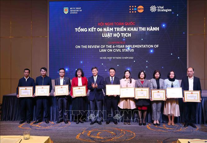 Thứ trưởng Bộ Tư pháp Nguyễn Khánh Ngọc trao Bằng khen của Bộ trưởng Bộ Tư pháp cho các cá nhân và tập thể có thành tích xuất sắc. Ảnh: Phạm Kiên - TTXVN