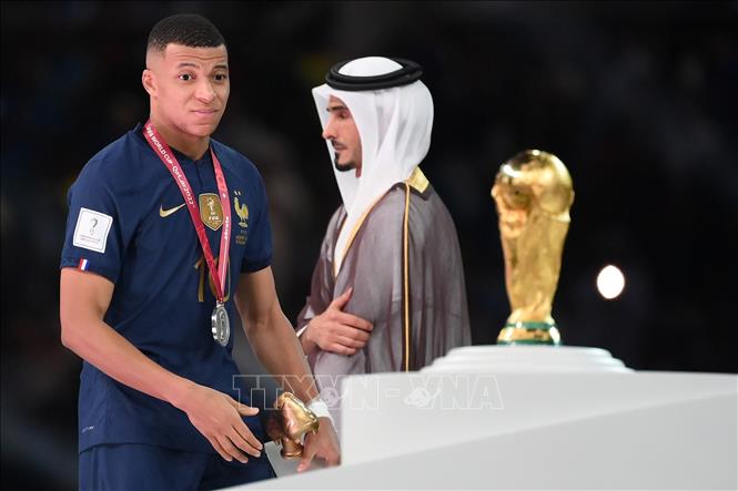 Cũng như L.Messi năm 2014, tiền đạo Mbappe (trái) có ánh nhìn đầy tiếc nuối chiếc Cup vô địch World Cup. Ảnh: AFP/TTXVN