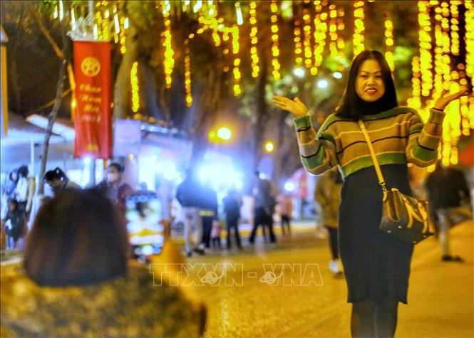 Người dân chụp ảnh lưu niệm tại không gian phố đi bộ Trần Nhân Tông. Ảnh: Tuấn Đức - TTXVN