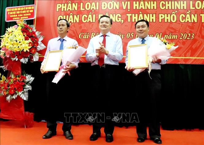 Ông Dương Tấn Hiển, Phó Chủ tịch Thường trực UBND thành phố Cần Thơ trao quyết định của Chủ tịch UBND thành phố phân loại đơn vị hành chính phường Hưng Thạnh và Tân Phú (thuộc quận Cái Răng) cho lãnh đạo chính quyền hai phường. Ảnh: Thu Hiền - TTXVN