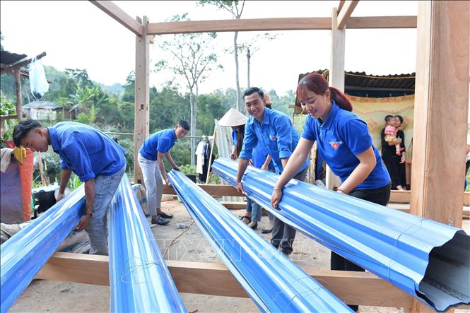 Các đoàn viên, thanh niên huyện Mường Nhé (Điện Biên) giúp đồng bào dân tộc Sila dân dựng nhà tại bản Nậm Sin, xã Chung Chải. Ảnh: Minh Đức – TTXVN