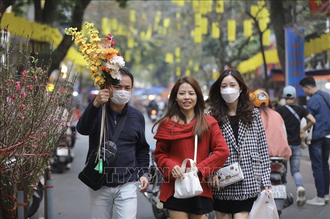 Young people also love to go shopping in Hang Luoc flower market. VNA Photo: Minh Quyết