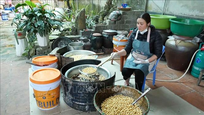 Người dân huyện vùng cao Lang Chánh làm kẹo nhãn Châu Lang. Ảnh: Nguyễn Nam-TTXVN