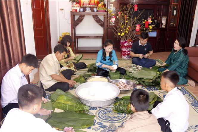 Trong ảnh: Bà Ma Thị Kim Cương cùng gia đình, bạn bè và con cháu đang cùng gói bánh chưng để ăn tết theo phong tục truyền thống của Việt Nam. Ảnh: Phạm Kiên - Phóng viên TTXVN tại Lào.