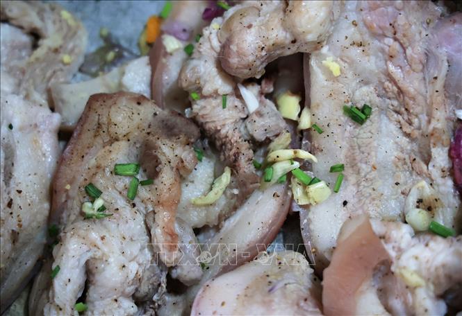 Pork belly seasoned with salt, pepper and green onions are used as fillings for banh tet. VNA Photo: Hồng Đạt