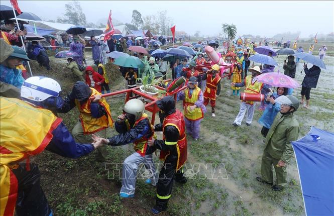Đoàn rước đi từ đình làng Mỏ qua nhiều khu vực ruộng lúa của nhân dân trong vùng. Ảnh: Anh Tuấn – TTXVN