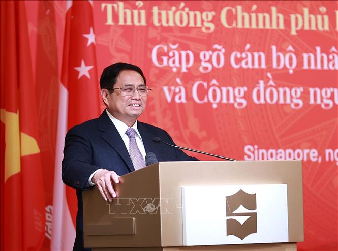 Thủ tướng Phạm Minh Chính phát biểu tại buổi gặp gỡ cán bộ, nhân viên các cơ quan đại diện và cộng đồng người Việt Nam tại Singapore. Ảnh: Dương Giang-TTXVN
