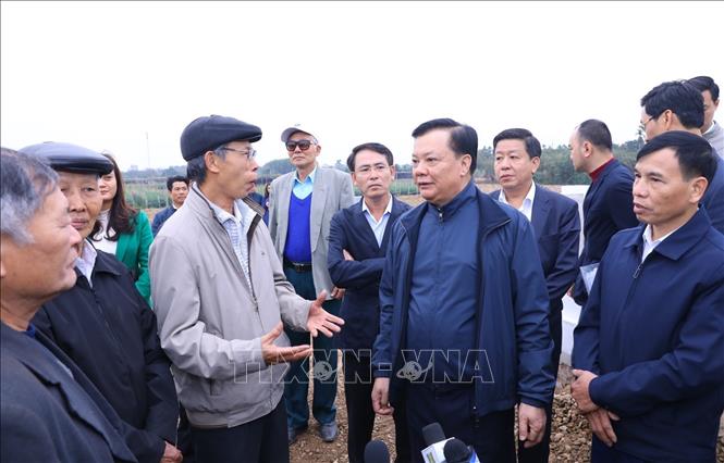 Bí thư Thành ủy Hà Nội Đinh Tiến Dũng kiểm tra thực địa tại địa điểm quy tập mộ tại nghĩa trang xã Hồng Hà, huyện Đan Phượng. Ảnh: Văn Điệp - TTXVN