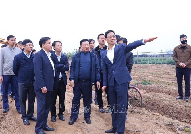 Bí thư Thành ủy Hà Nội Đinh Tiến Dũng kiểm tra thực địa tại địa điểm quy tập mộ tại nghĩa trang xã Hồng Hà, huyện Đan Phượng. Ảnh: Văn Điệp - TTXVN