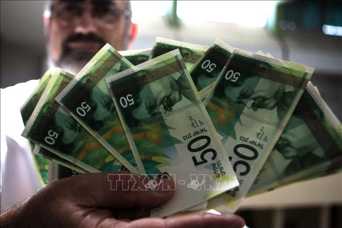 Đồng tiền mệnh giá 50 shekels của Israel. Ảnh: AFP/TTXVN