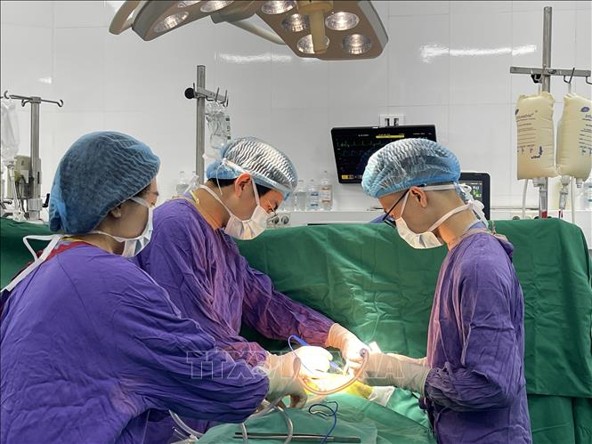 Doctors conduct the surgery on February 15. Photo by courtesy/VNA