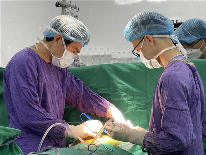 Doctors conduct the surgery on February 15. Photo by courtesy/VNA