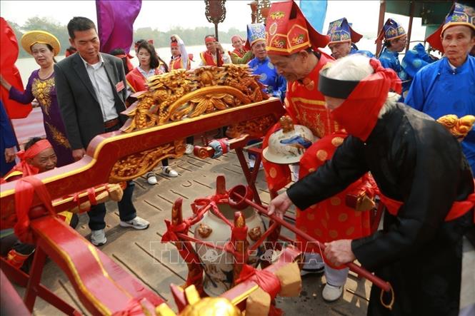 The rite of fetching water from the Red River for procession to Da Hoa temple. VNA Photo: Mai Ngoan