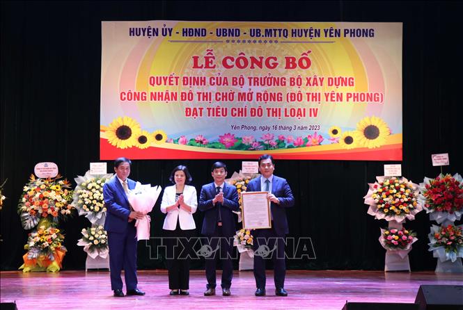 Chủ tịch UBND tỉnh Bắc Ninh Nguyễn Hương Giang (thứ 2 từ trái) trao Quyết định của Bộ trưởng Bộ Xây dựng công nhận đô thị Chờ mở rộng là đô thị loại IV. Ảnh: Thái Hùng-TTXVN