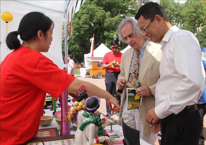 Đại sứ Việt Nam tại Argentina và Thứ trưởng Ngoại giao nước chủ nhà Pablo Tettamanti thăm gian hàng Việt Nam tại hội chợ. Ảnh: Ngọc Tùng - PV TTXVN tại Argentina 