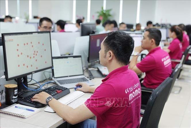 MoMo staff working in the office. VNA Photo: Tiến Lực
