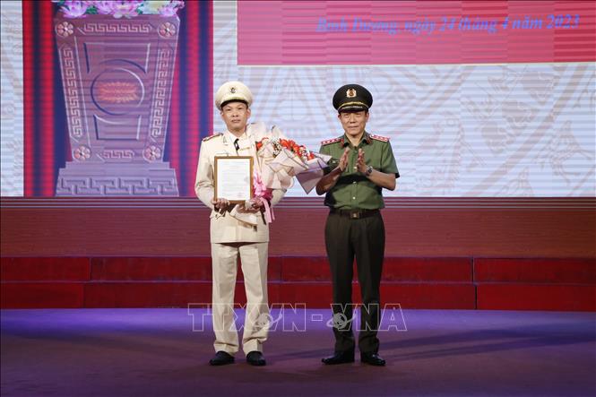 Thượng tướng Lương Tam Quang, Thứ trưởng Bộ Công an trao Quyết định của Bộ trưởng Bộ Công an về việc điều động và bổ nhiệm Đại tá Tạ Văn Đẹp giữ chức vụ Giám đốc Công an tỉnh Bình Dương. Ảnh: TTXVN phát