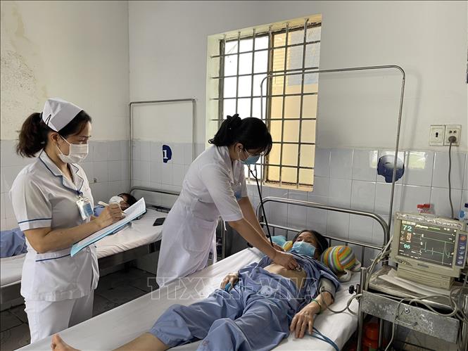 Các nhân viên y tế của Bệnh viện Quân y 4 chăm sóc, trả kết quả cho người bệnh. Ảnh: Huyền Trang - TTXVN