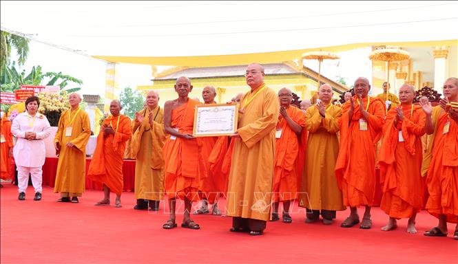 Hòa thượng Thích Thanh Nhiễu (phải), Phó Chủ tịch thường trực Hội đồng Trị sự Giáo hội Phật giáo Việt Nam tặng bằng tuyên dương công đức cho các tập thể, cá nhân có nhiều đóng góp tích cực trong công tác Phật sự và Học viện Phật giáo Nam tông Khmer. Ảnh: Thu Hiền - TTXVN