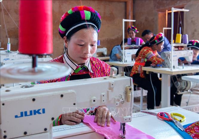 Trong ảnh: Người dân Phù Lá học và lao động tại xưởng may trang phục truyền thống tại trung tâm thôn Chúng Chải, xã Nàn Xỉn (Xín Mần, Hà Giang). Ảnh: Nam Thái - TTXVN