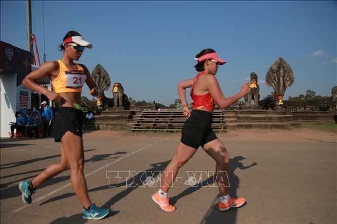 VĐV điền kinh Nguyễn Thị Thanh Phúc (áo đỏ) thi đấu xuất sắc, giành HCV nội dung đi bộ 20km. Ảnh: AKP/TTXVN