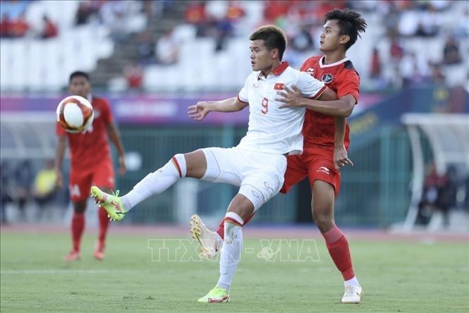 Striker Van Tung (9) fights for the ball with an Indonesian rival. VNA Photo