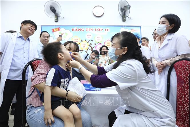 Bộ trưởng Bộ Y tế Đào Hồng Lan cho trẻ uống vitamin A. Ảnh: Minh Quyết - TTXVN