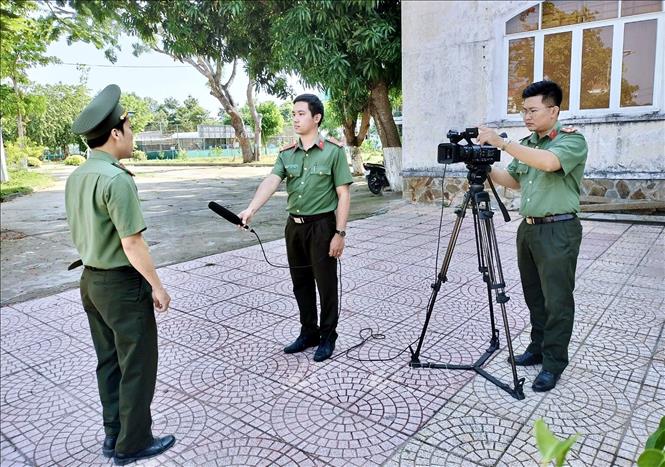 Cán bộ, chiến sĩ Đội Tuyên truyền, thi đua, khen thưởng thực hiện phóng sự kỷ niệm 75 năm ngày Công an nhân dân thực hiện 6 điều Bác Hồ dạy. Ảnh: TTXVN phát
