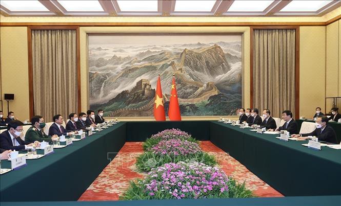 PM Pham Minh Chinh meets with Chairman of the National Committee of Chinese People's Political Consultative Conference Wang Huning. VNA Photo: Dương Giang 