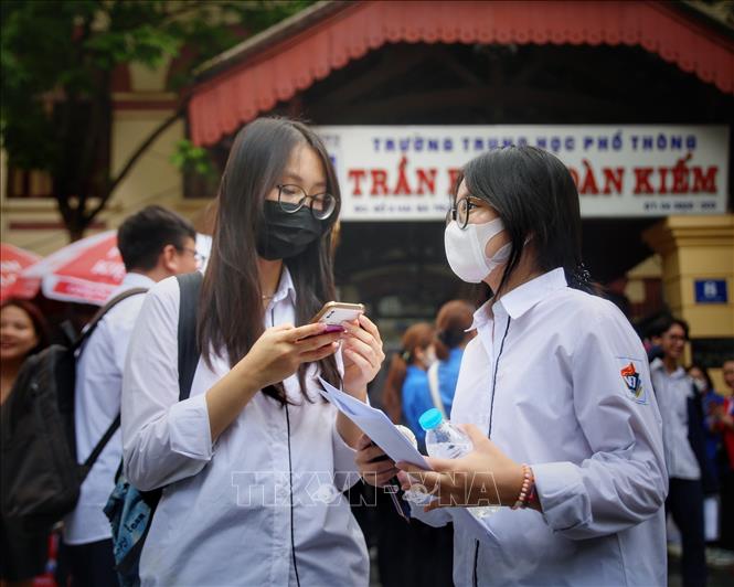 Các thí sinh trao đổi bài làm tại điểm thi trường THPT Trần Phú. Ảnh: Tuấn Đức - TTXVN