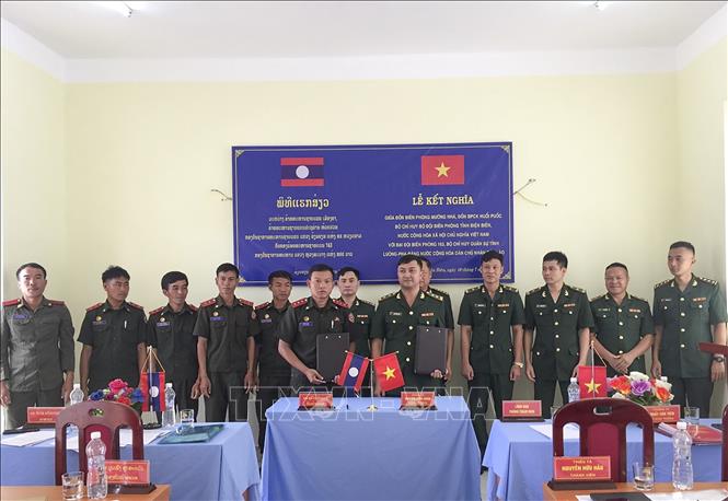 Trong ảnh: Trao biên bản ký kết nghĩa giữa Đồn Biên phòng Mường Nhà và Đại đội Biên phòng 163, Lào. Ảnh: TTXVN phát