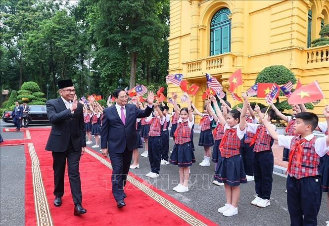 Prime Minister Pham Minh Chinh welcomes his Malaysian guest Anwar Ibrahim. VNA Photo: Dương Giang