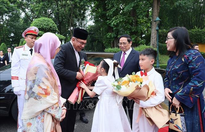 Prime Minister Pham Minh Chinh and his spouse welcome Malaysian counterpart Anwar Ibrahim and his spouse. VNA Photo: Dương Giang