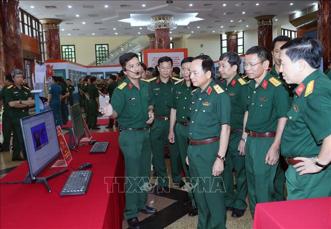Trung tướng Trịnh Văn Quyết, Ủy viên Trung ương Đảng, Phó Chủ nhiệm Tổng cục Chính trị Quân đội nhân dân Việt Nam và các đại biểu tham quan trưng bày, giới thiệu tài liệu tham khảo, giảng dạy chính trị của các đơn vị. Ảnh: Trọng Đức - TTXVN