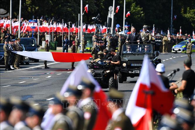 Tổng thống Ba Lan Andrzej Duda (trái, trên xe) và Tổng Tham mưu trưởng các lực lượng vũ trang Ba Lan, Tướng Rajmund Andrzejczak (phải, trên xe) tại lễ duyệt binh kỷ niệm Ngày Quân đội ở Vacsava, ngày 15/8/2023. Ảnh: PAP/TTXVN