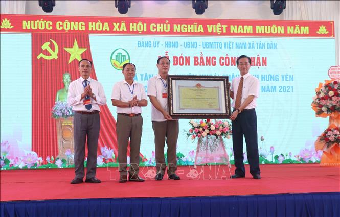 Lãnh đạo Sở Nông nghiệp và Phát triển Nông thôn tỉnh Hưng Yên trao Bằng công nhận đạt chuẩn Nông thôn mới kiểu mẫu cho xã Tân Dân. Ảnh: Đinh Văn Nhiều - TTXVN
