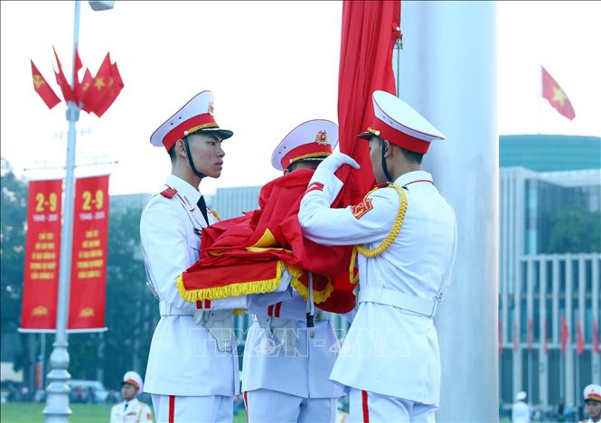 Soldiers carry the national flag towards the flagpole to prepare for the ceremony. VNA Photo: Phạm Kiên 