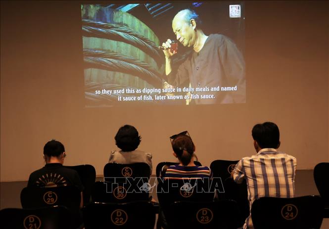 Visitors watch a documentary on the 300-year-old tradition of fish sauce making in Phan Thiet city. VNA Photo: Hồng Đạt