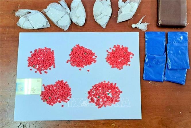 Lực lượng Công an đã phát hiện, thu giữ tang vật Lò Văn Kim mang theo gồm 5 túi nilon chứa cục một màu trắng và 5 túi nilon màu xanh, bên trong chứa 1.000 viên nén ma túy tổng hợp. Ảnh: TTXVN phát