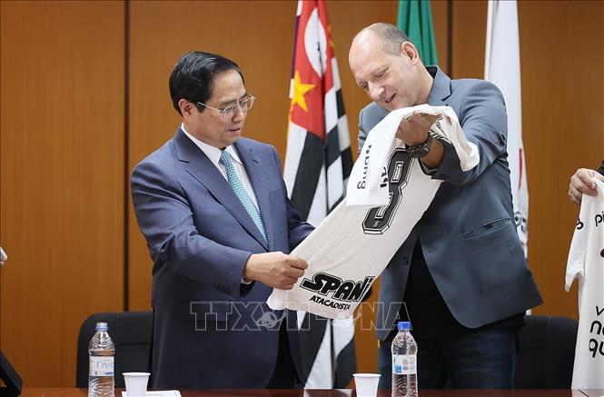 Ông Luiz Wagner Alcantara, Phó Chủ tịch CLB Corinthians Paulista tặng Thủ tướng Phạm Minh Chính chiếc áo thi đấu của CLB. Ảnh: Dương Giang-TTXVN
