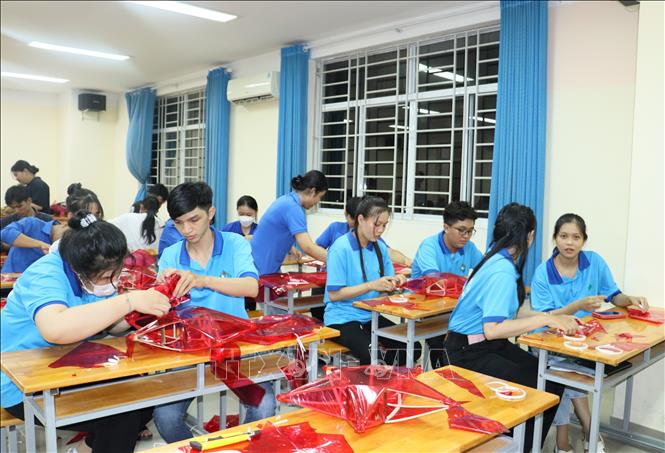 Sinh viên Trường Đại học Sư phạm Kỹ thuật Vĩnh Long cùng làm lồng đèn ngôi sao truyền thống tặng thiếu nhi. Ảnh: Lê Thúy Hằng - TTXVN