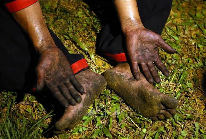 A dancer's hands and feet after jumping over the burning coals without any burn marks. VNA Photo: Quý Trung