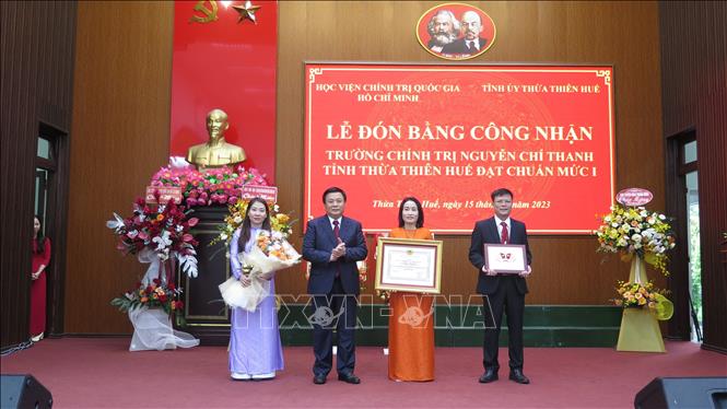 Đồng chí Nguyễn Xuân Thắng, Ủy viên Bộ Chính trị, Giám đốc Học viện Chính trị Quốc gia Hồ Chí Minh, Chủ tịch Hội đồng Lý luận Trung ương, trao bằng và biểu trưng công nhận đạt chuẩn mức 1 cho lãnh đạo nhà trường. Ảnh: Tường Vi - TTXVN. 