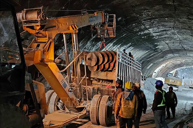 Ngày 16/11/2023, nhà chức trách Ấn Độ cho biết lực lượng chức năng đang tập trung khoan xuyên qua một tảng đá rơi để lắp đặt một đường ống có thể đưa các nạn nhân bị mắc kẹt trong vụ sập đường hầm ở bang Uttarakhand, miền Bắc nước này, ra ngoài an toàn. Lực lượng cứu hộ đã chuyển thuốc men, cùng với thực phẩm và bơm khí oxy xuống khu vực trú ngụ của 40 công nhân mắc kẹt. Ảnh: AFP/TTXVN