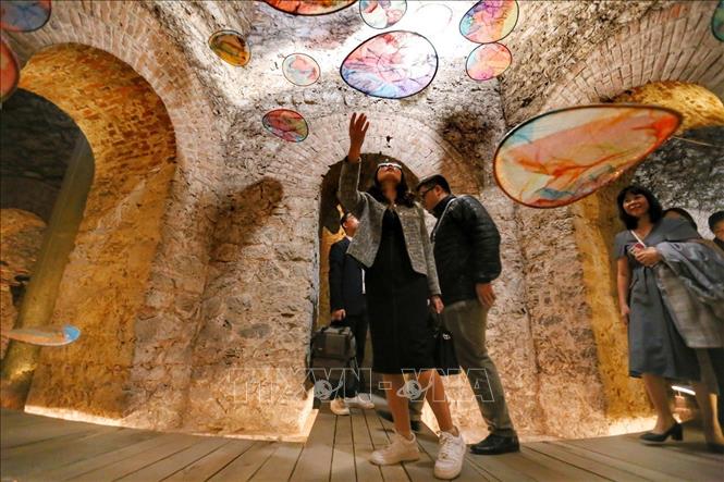 Visitors in Hang Dau water tower with an art space of installation systems. VNA Photo: Tuấn Đức