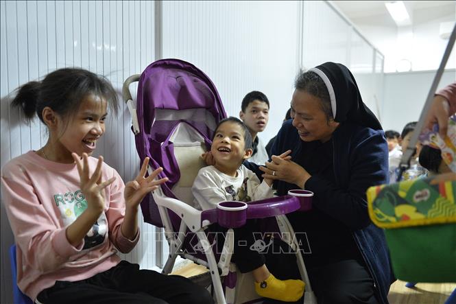 Niềm vui của Nữ tu Catarina Trần Thị Thắm, Tổng phụ trách Dòng mến Thánh giá Phát Diệm với các trẻ em khuyết tật tại cơ sở. Ảnh: Minh Đức - TTXVN