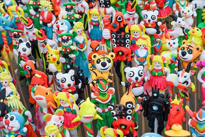 Toy figurines captivate children's attention with their cute designs and colourful details. VNA Photo: Khánh Hòa