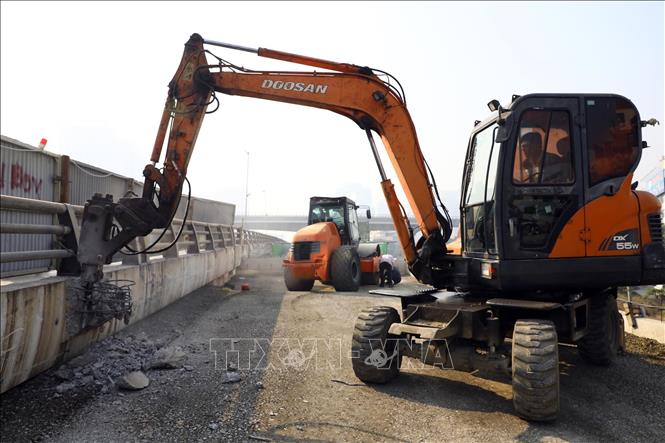 Thi công phần đường dẫn bên phía Phạm Văn Đồng. Ảnh: Huy Hùng - TTXVN 