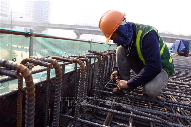 Công nhân đang tiến hành thi công phần cốt thép bản mặt cầu để chuẩn bị đổ bêtông. Ảnh: Huy Hùng - TTXVN 